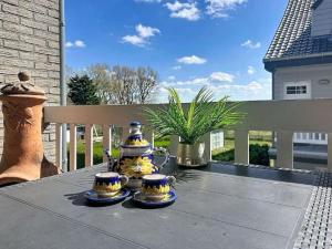 a table with two vases sitting on top of it at Apartment The Horseshoe with parking by Interhome in Bredene