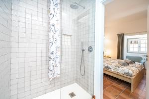 a bathroom with a shower and a bed at Apartamento Karolvaz V in Silves +19 photos