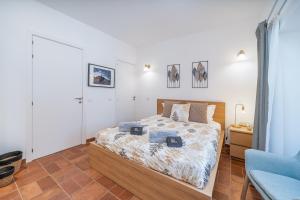 a bedroom with a bed and a blue chair at Apartamento Karolvaz V in Silves