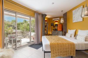 a bedroom with a large bed and a balcony at Lointaines escapades in Perpignan +107 photos