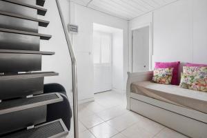 a white room with a bed and a mirror at Casa Branca in Ribeiras +19 photos