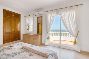 a bedroom with a bed and a large window at Tossal Gros in La Font D´En Carròs +18 photos