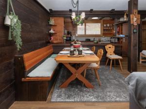 a dining room with a wooden table and chairs at Apartment SnowKaya Grindelwald by Interhome in Grindelwald +33 photos