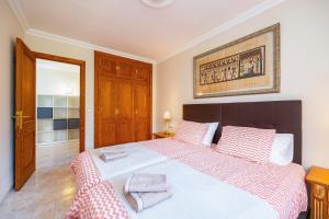 a bedroom with a large white bed with two pillows at Can Navarro in Port de Soller