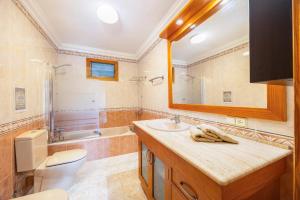 a bathroom with a toilet and a sink and a mirror at Can Navarro in Port de Soller +23 photos