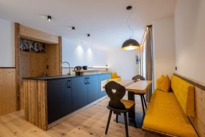 a kitchen and dining room with a table and chairs at Ladinser Hof Kuschelecke in Castelrotto