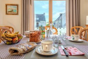 a dining room table with a table cloth with food on it at Chambre d'hôtes à Lesneven in Lesneven +14 photos