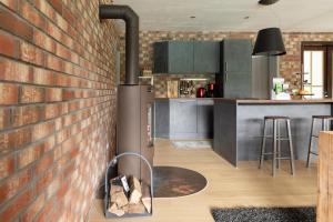 a kitchen with a brick wall and a stove at Fewo einzigartige Aussicht im Harz in Walkenried +13 photos