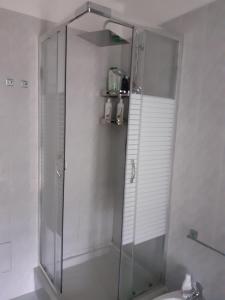 a shower with a glass door in a bathroom at La Casa di Aldo 15 minuti da Torino in Pecetto +13 photos