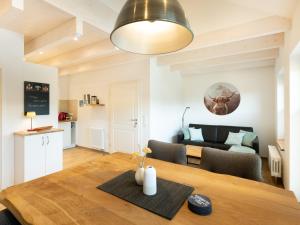 a dining room and living room with a wooden table at Ferienwohnung Verschnuufeckli in Wehr