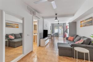 a living room with two couches and a television at Vv Ancla in Puerto de Mogán