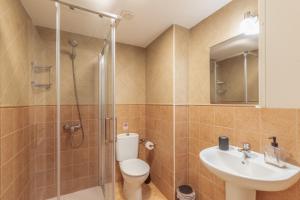 a bathroom with a toilet and a sink and a shower at Vv Ancla in Puerto de Mogán +24 photos