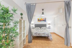 a bedroom with a bed and plants in it at Vv Ancla in Puerto de Mogán
