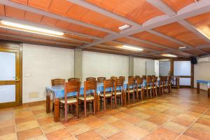 a room with a row of tables and chairs at Rural Mas Vila in Fogás de Tordera +66 photos