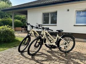 two bikes are parked in front of a house at Ferienhaus Marlen in Naumburg