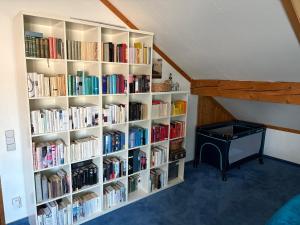 a book shelf filled with books in a room at Ferienhaus Unteres Hart in Gomadingen +17 photos