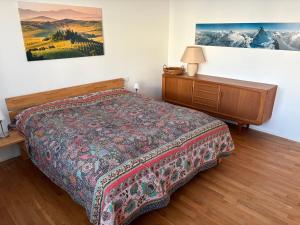 a bedroom with a bed and a dresser at Ferienhaus Unteres Hart in Gomadingen