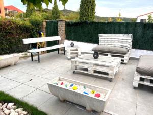 a patio with two chairs and a table and a sandbox at Amets in Yesa