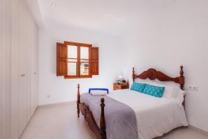 a bedroom with a large bed in a white room at Villa Cas Siulet in Alcudia