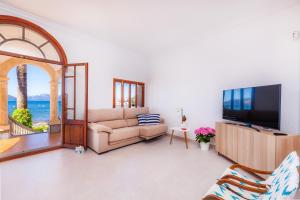 a living room with a couch and a tv at Villa Cas Siulet in Alcudia