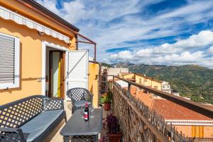 a balcony of a house with a table and chairs at Affittacamere Da Riccardo in Jerzu