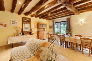 a living room with a table and chairs at La Ferme de la Croix d'Allon in Sarlat-la-Canéda