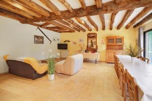 a living room with a couch and a table at La Ferme de la Croix d'Allon in Sarlat-la-Canéda