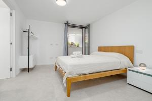 a white bedroom with a bed and a mirror at Villa Mirtina - by And Service in Golfo Aranci +22 photos