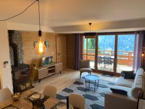 a living room with a couch and a table at Flambeaux A 12 Roca immobilier in Châtel