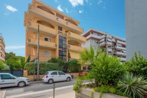 a building with cars parked in front of it at Villafiorita in Alghero