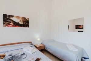 two beds sitting next to each other in a room at Casa Margiulu’ - Partanna in Partanna +20 photos