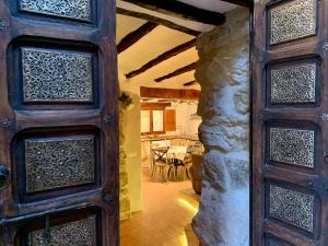a wooden door in a room with a table at La Casuca in Olba