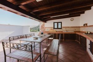 a kitchen with a table and chairs in a room at Casa Margiulu’ - Partanna in Partanna