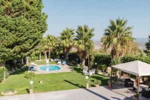 an aerial view of a backyard with a pool and palm trees at Casa Margiulu’ - Partanna in Partanna