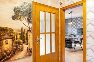 a door leading into a dining room with a painting on the wall at Marisa's Sauerlandträumchen in Brilon