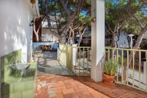 a balcony with a table and chairs and trees at Old Side Duplex Platja d Aro in Platja d'Aro