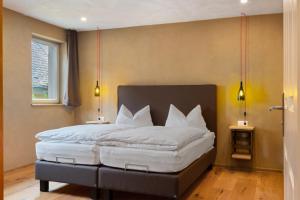 a bedroom with a large bed with white pillows at Bio Bausewein - No.1 Apartment in Iphofen