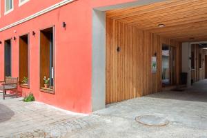 an orange building with a wooden door on the side at Bio Bausewein - No.1 Apartment in Iphofen