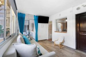 a living room with blue curtains and a couch at Casa Nene in La Matanza de Acentejo