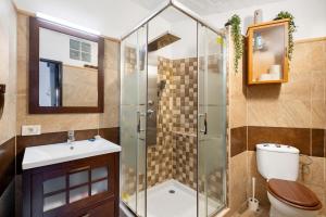 a bathroom with a shower with a toilet and a sink at Casa Nene in La Matanza de Acentejo +29 photos