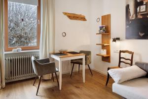 a living room with a table and chairs and a window at Landhaus Trautwein in Vogtsburg