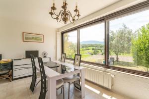 a home office with a desk and a large window at Maison Avec Vue Sur Le Ventoux in Faucon