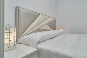 a white bedroom with a large bed with white sheets at Great views studio A84 in Torrox +17 photos