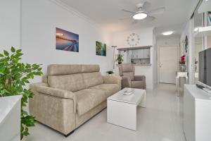a living room with a couch and a table at Great views studio A84 in Torrox