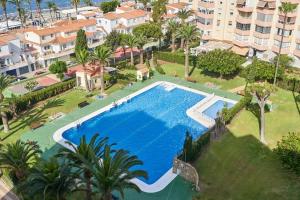 an overhead view of a large swimming pool with palm trees and buildings at Great views studio A84 in Torrox