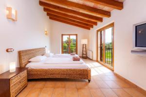 a bedroom with a large bed and a television at Finca Mirador Capdepera in Capdepera +36 photos