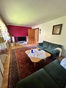 a living room with a couch and a table at Haus Marianne in Bischofswiesen