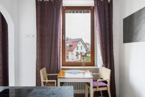 a room with a table and a window with a house at Landhaus Trautwein in Vogtsburg