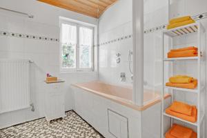 a white bathroom with a tub and a shower at Haus Marianne in Bischofswiesen +11 photos