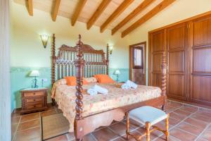 a bedroom with a bed and a chair in a room at Can Pedro - Sa Torre Nova in Son Carrió